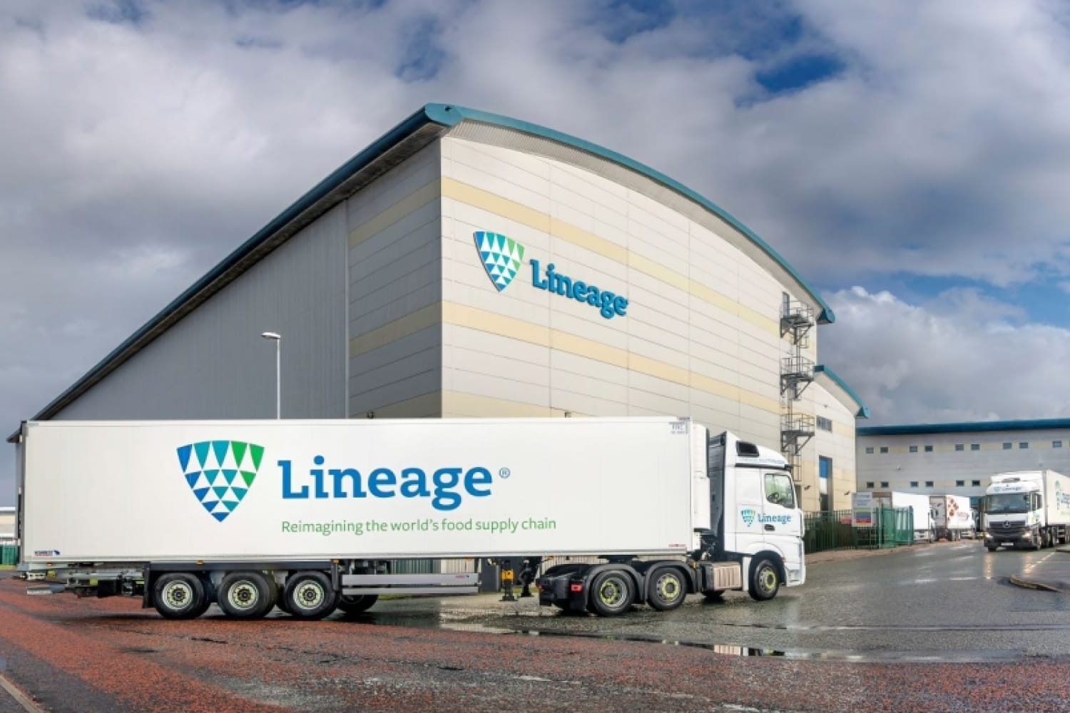 A Lineage Logistics truck, emblazoned with the company's logo, is parked in front of their facility. 

Image Source: Detroit Labs 